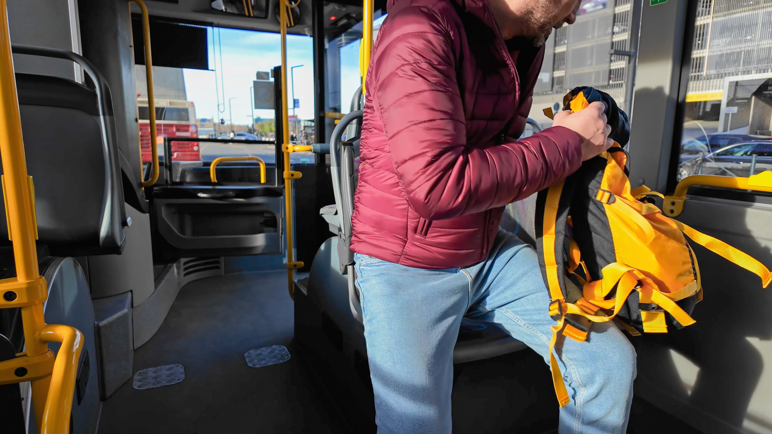 Commuter inside a bus at city station.